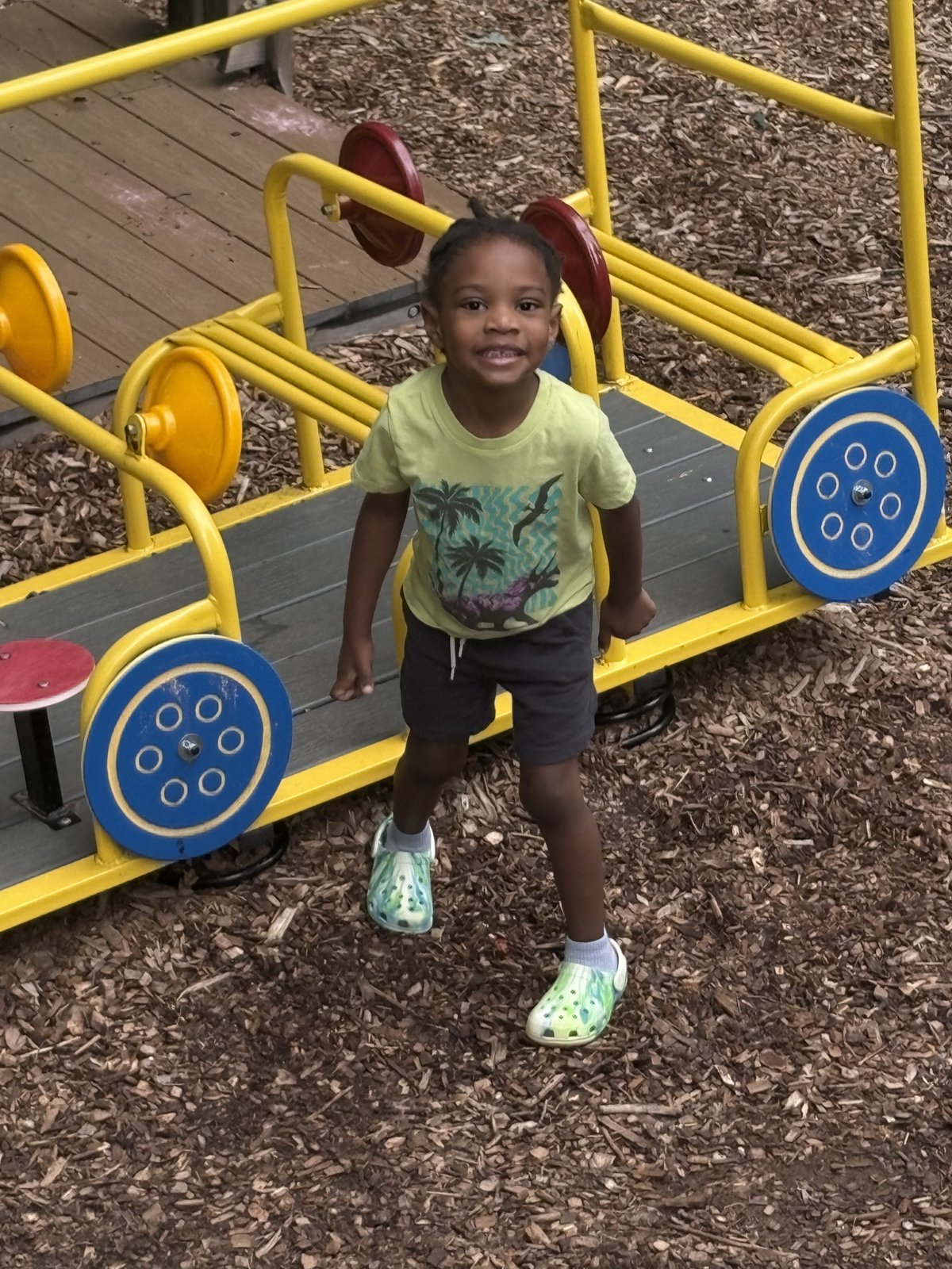 Happy scholar playing on our outdoor playground