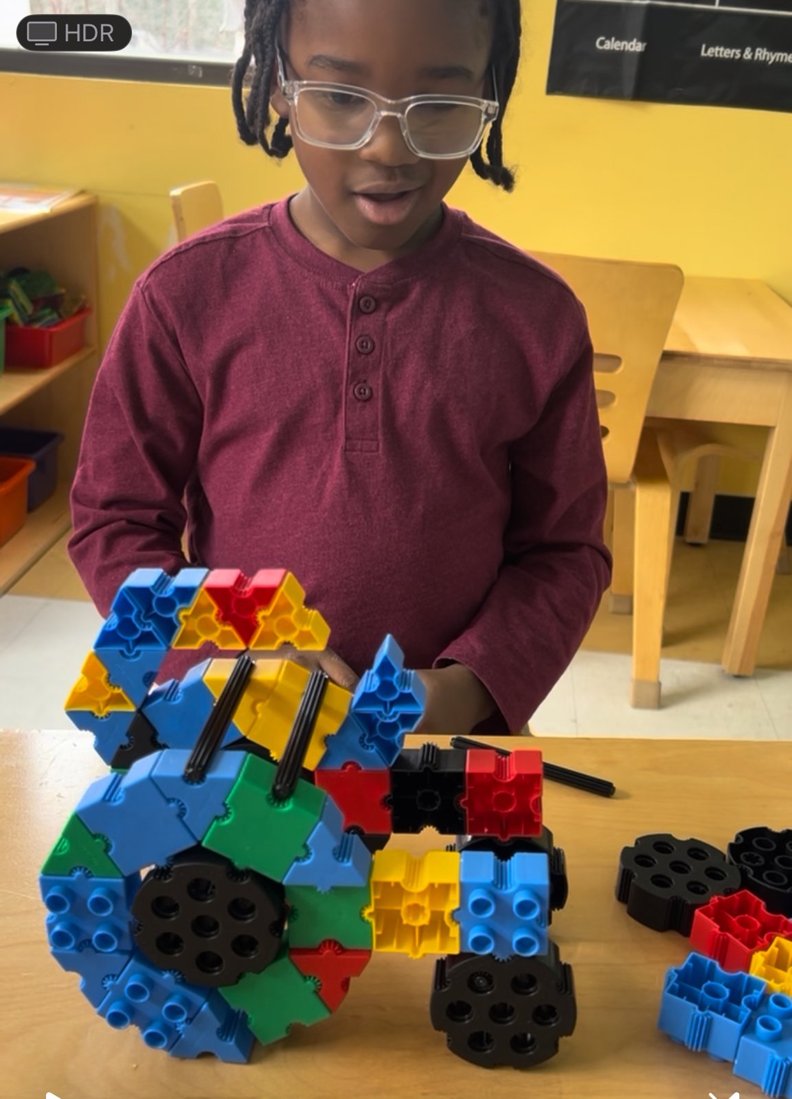 Scholar engineering with colorful STEM building blocks